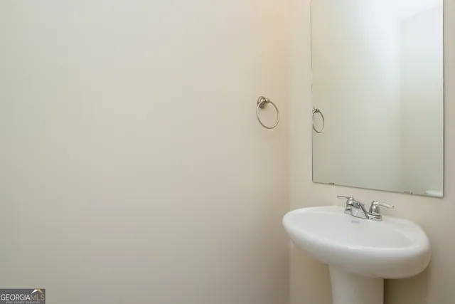 a bathroom with a sink and mirror