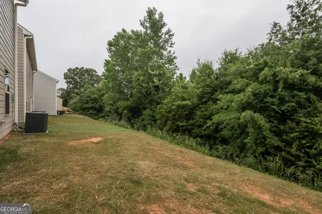 a view of a yard with plants and a trees