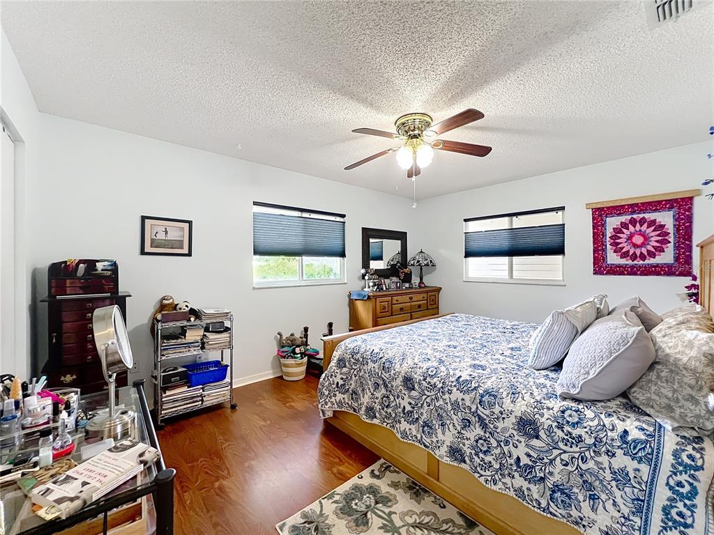 6468 Southwest 107th Place Ocala, FL 34476 - Photo 13 of 53 a bedroom with a bed and a chandelier