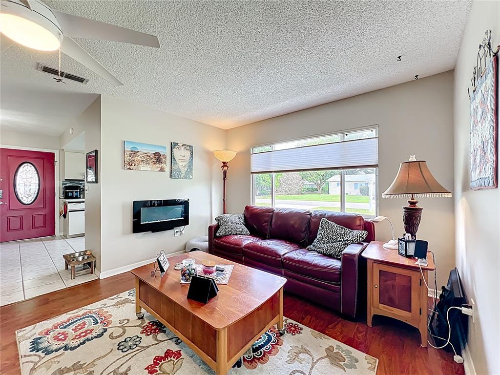 6468 Southwest 107th Place Ocala, FL 34476 - Photo 14 of 53 a living room with furniture and a wooden floor