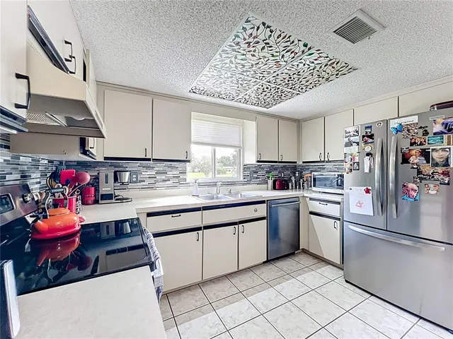 a kitchen with a large window and a sink