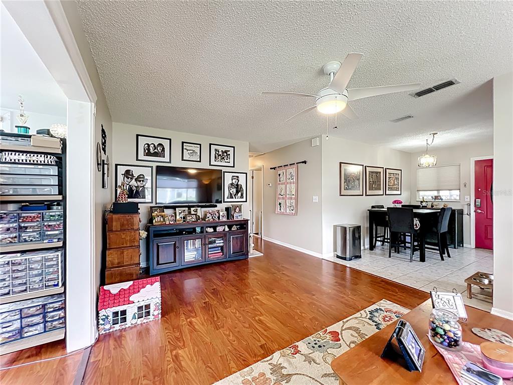 6468 Southwest 107th Place Ocala, FL 34476 - Photo 28 of 53 a living room with furniture and a flat screen tv