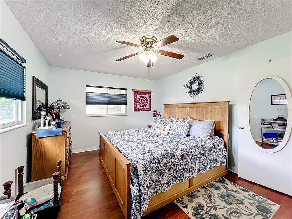 6468 Southwest 107th Place Ocala, FL 34476 - Photo 31 of 53 a bedroom with bed and a chandelier