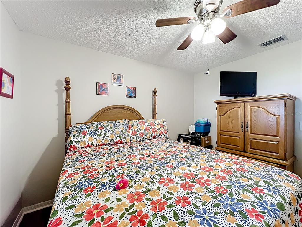 6468 Southwest 107th Place Ocala, FL 34476 - Photo 34 of 53 a bedroom with a bed and a television