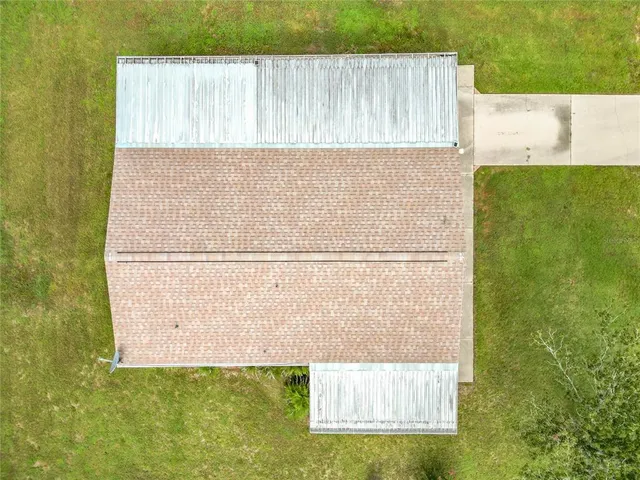 an aerial view of residential houses with outdoor space and swimming pool