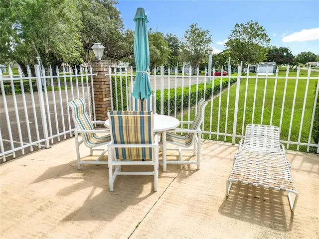 a view of swimming pool with a yard and trees