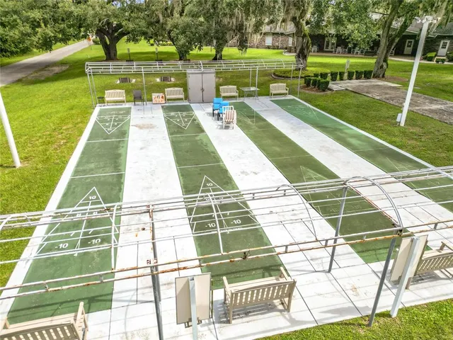 an aerial view of residential houses with outdoor space and swimming pool