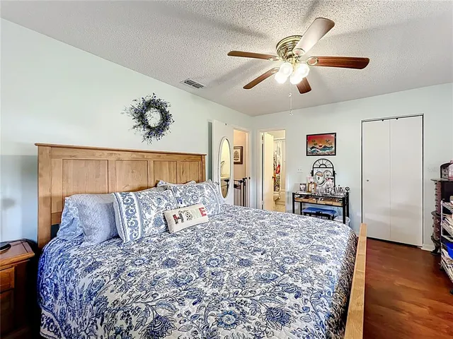 a bedroom with a large bed and a chandelier