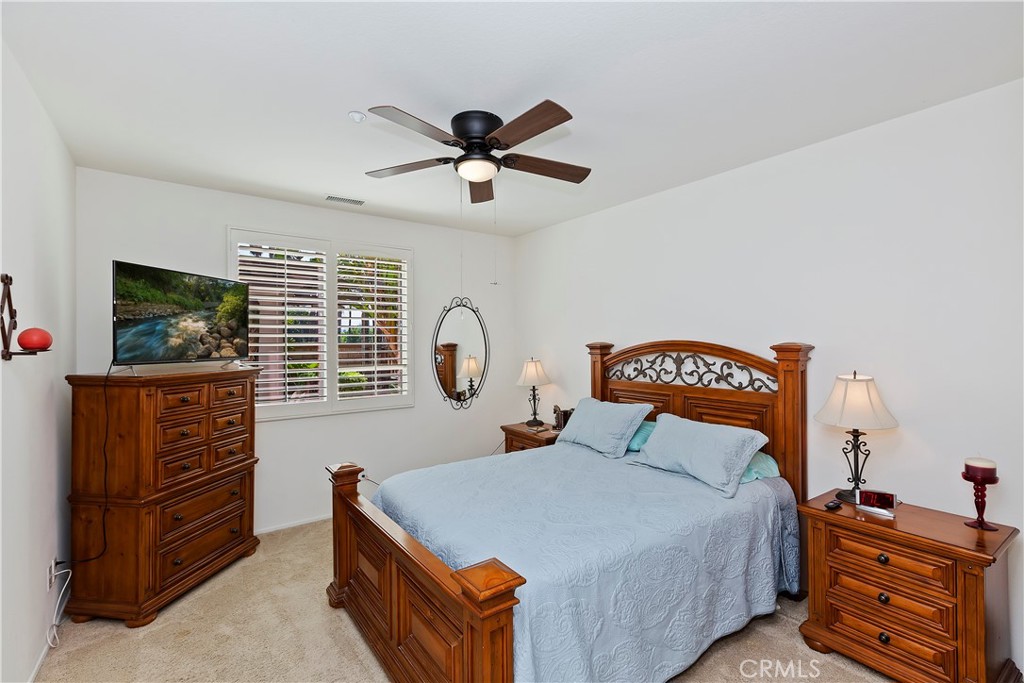 11416 Bridgeway Drive Riverside, CA 92505 - Photo 23 of 54 a bedroom with a bed and a flat tv screen on dresser