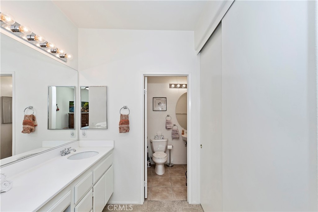 11416 Bridgeway Drive Riverside, CA 92505 - Photo 24 of 54 a spacious bathroom with a double vanity sink a mirror and a toilet