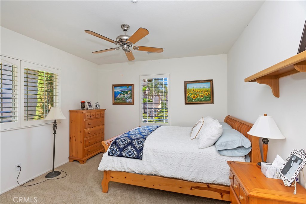 11416 Bridgeway Drive Riverside, CA 92505 - Photo 35 of 54 a bedroom with a bed and wooden floor