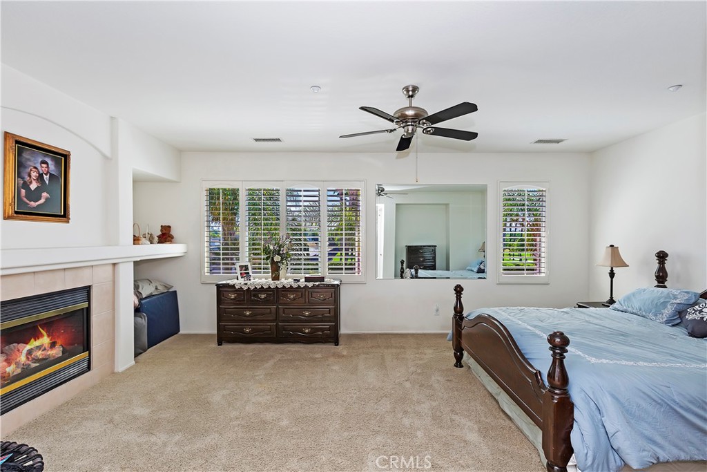 11416 Bridgeway Drive Riverside, CA 92505 - Photo 37 of 54 a bed room with furniture and a fireplace