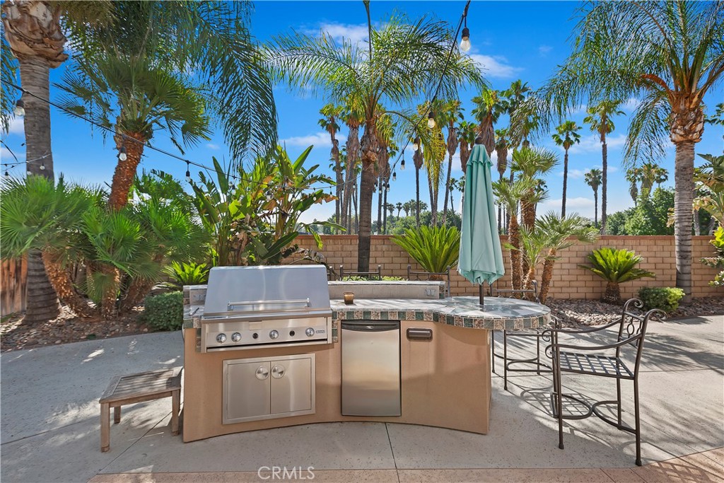 11416 Bridgeway Drive Riverside, CA 92505 - Photo 43 of 54 a table and chairs sitting in a backyard with palm trees