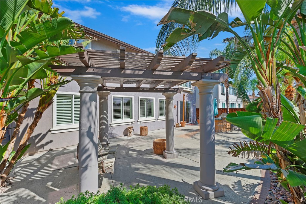 11416 Bridgeway Drive Riverside, CA 92505 - Photo 47 of 54 a view of a house with a small yard plants and large tree