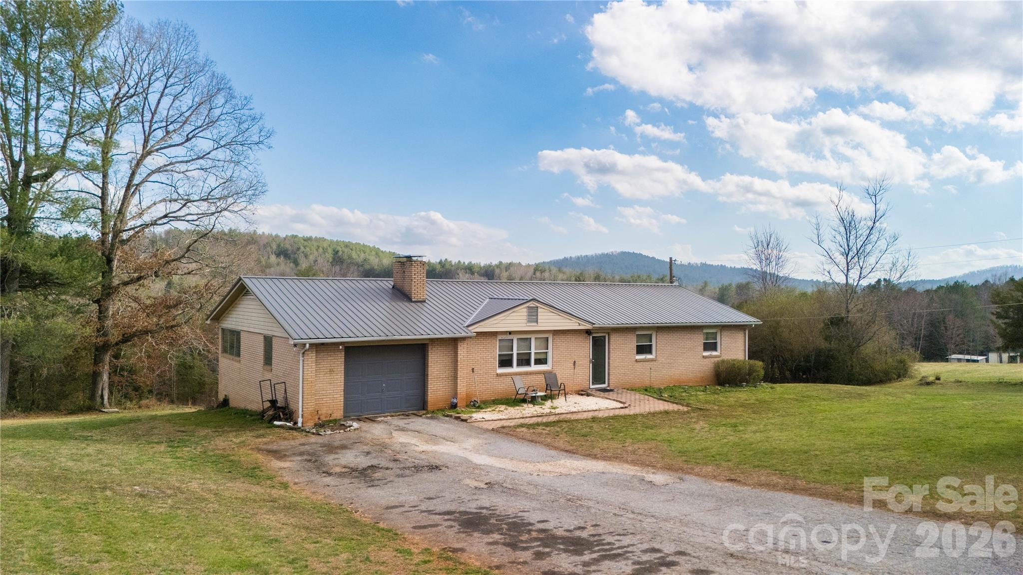 4636 Oak Hill School Road Lenoir, NC 28645 - Photo 1 of 23 a front view of a house with a garden and pathway