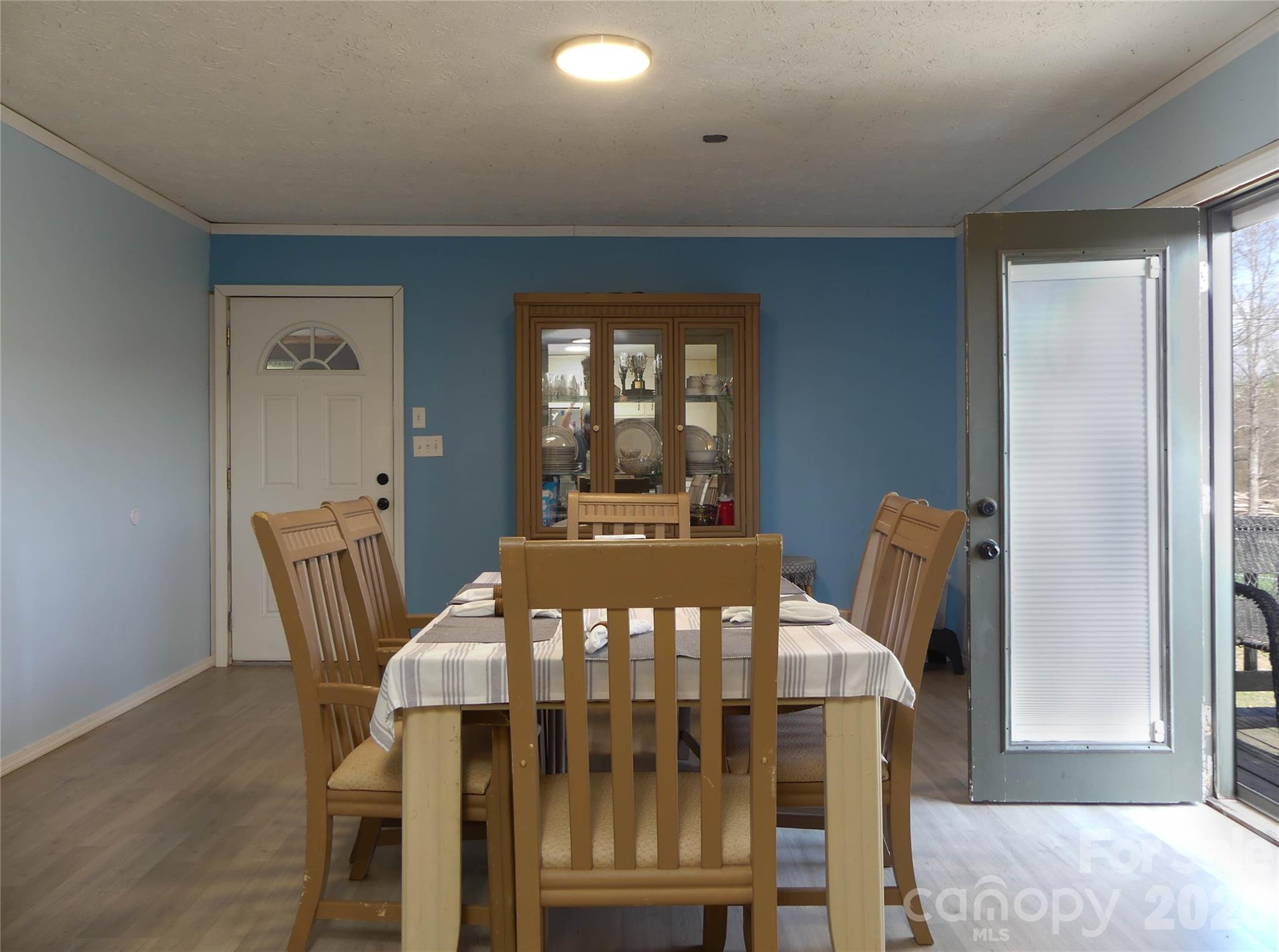 4636 Oak Hill School Road Lenoir, NC 28645 - Photo 11 of 23 a view of a dining room with furniture and wooden floor