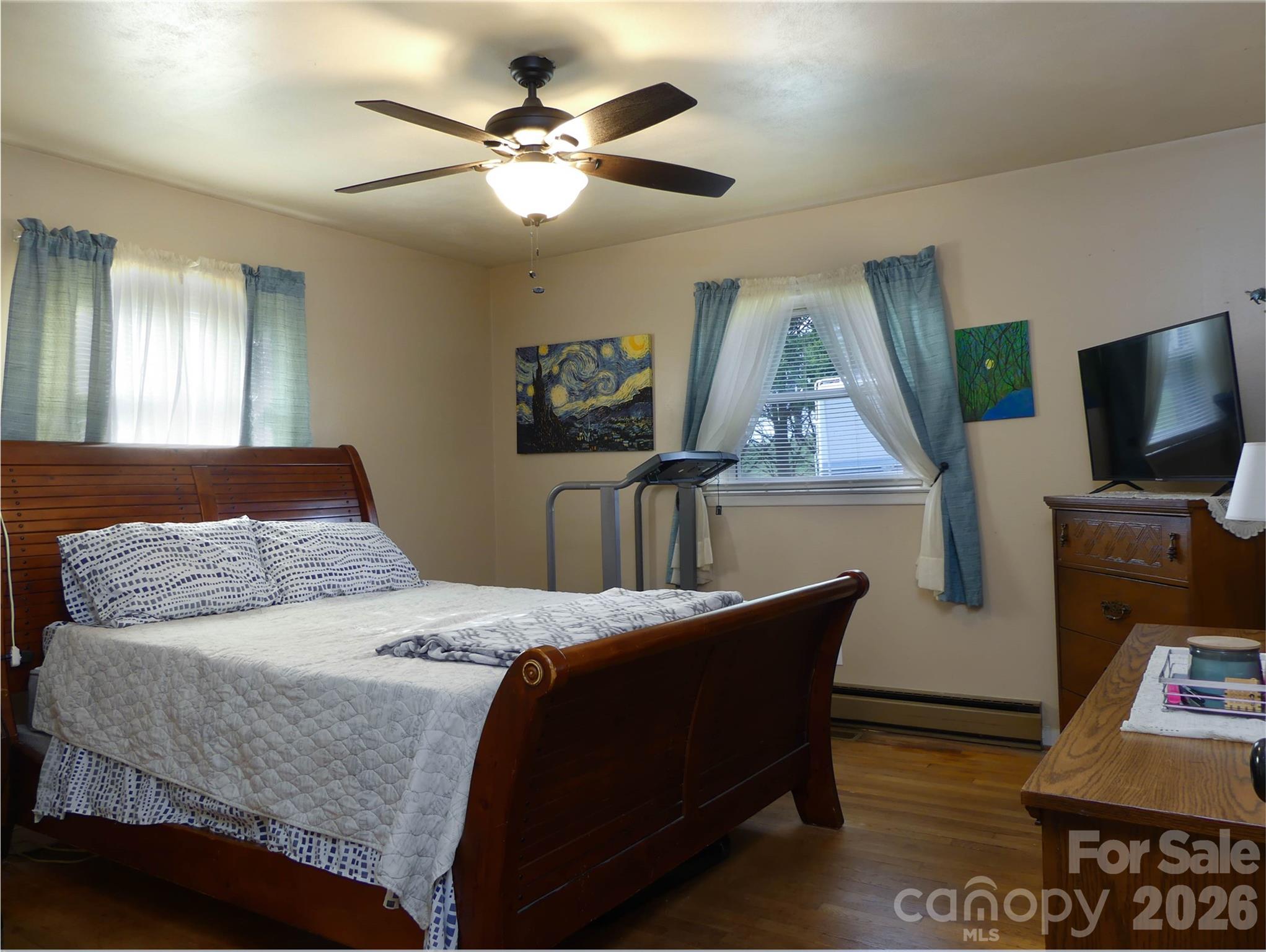4636 Oak Hill School Road Lenoir, NC 28645 - Photo 16 of 23 a bedroom with a bed and a flat screen tv
