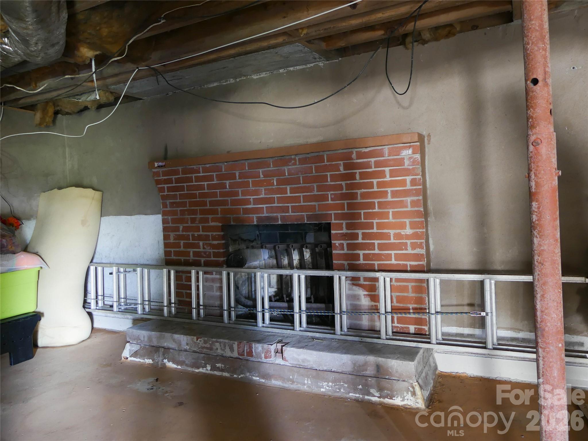 4636 Oak Hill School Road Lenoir, NC 28645 - Photo 21 of 23 a view of a fireplace with a chair