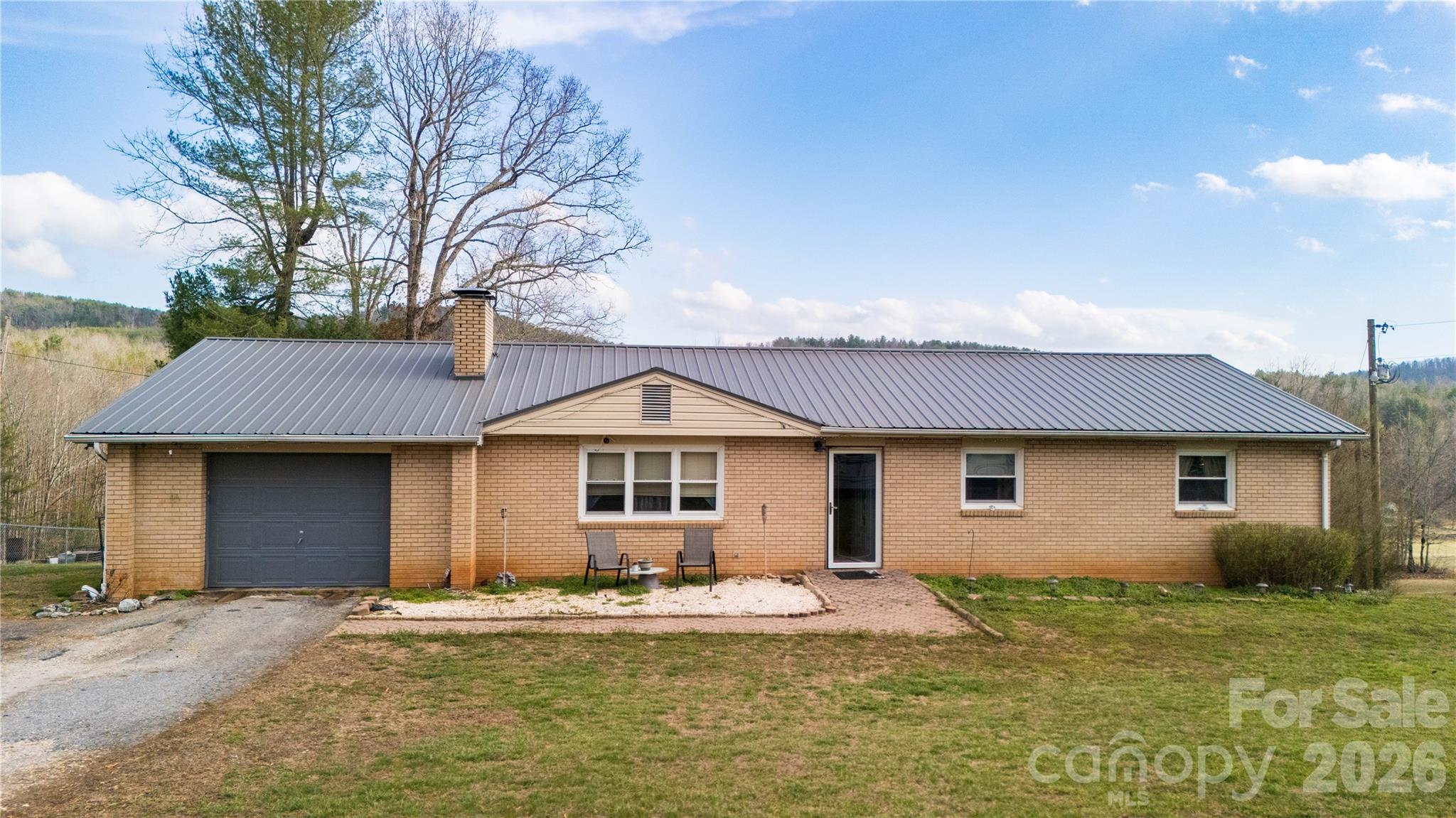 4636 Oak Hill School Road Lenoir, NC 28645 - Photo 3 of 23 a front view of a house with a garden and yard