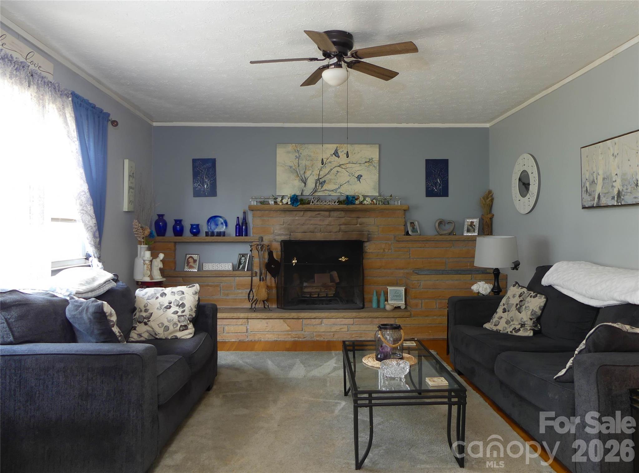 4636 Oak Hill School Road Lenoir, NC 28645 - Photo 6 of 23 a living room with furniture and a fireplace