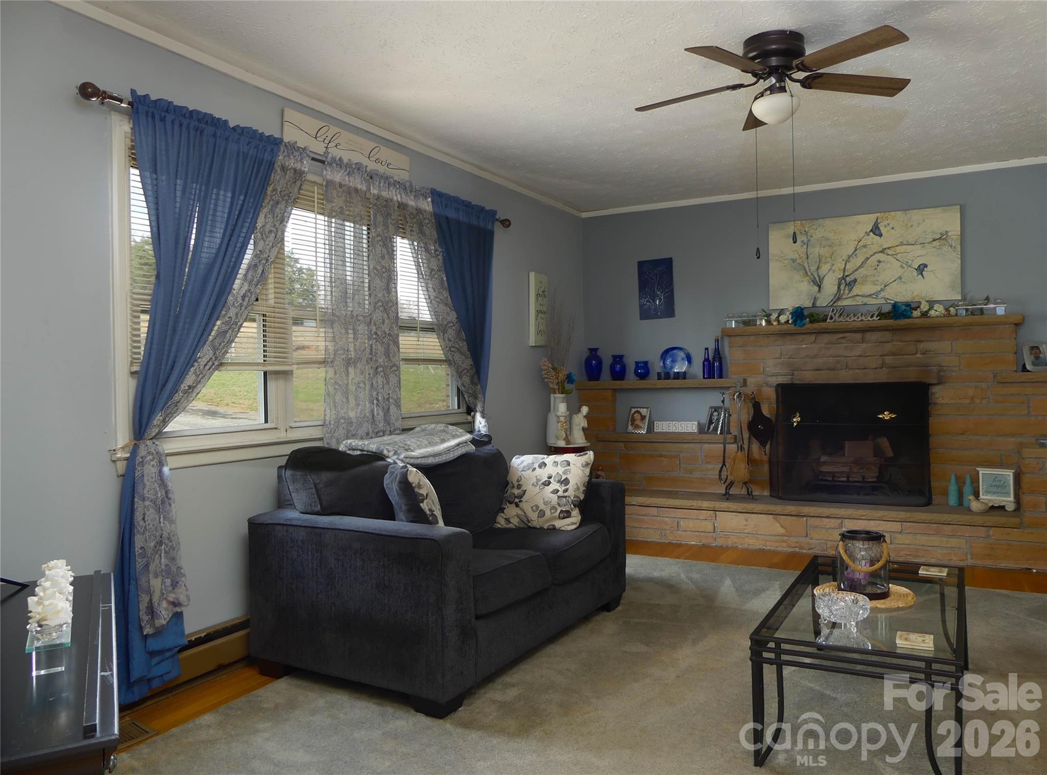 4636 Oak Hill School Road Lenoir, NC 28645 - Photo 7 of 23 a living room with furniture and a fireplace
