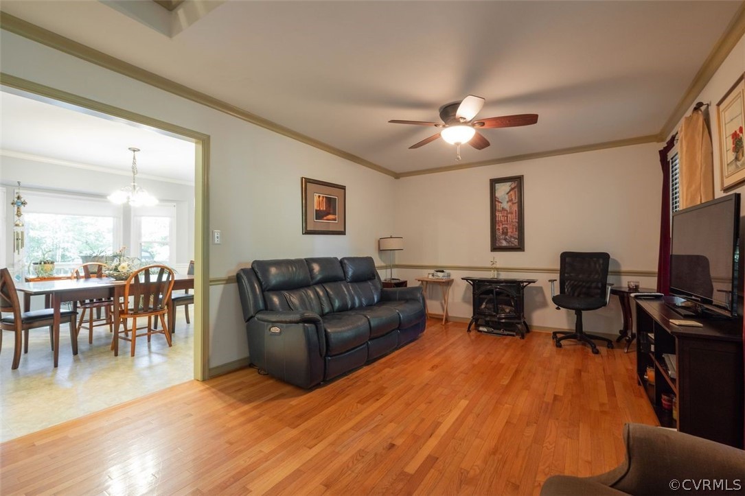 2734 Sutherland Road Sutherland, VA 23885 - Photo 6 of 28 a living room with furniture a dining table and a flat screen tv