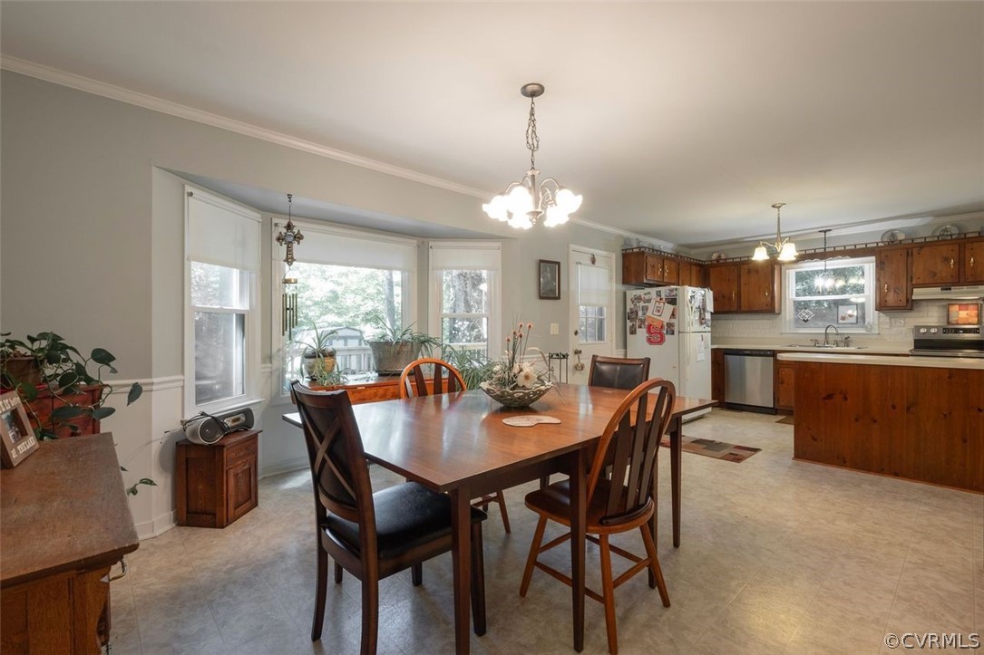 2734 Sutherland Road Sutherland, VA 23885 - Photo 8 of 28 a dining room with furniture a chandelier and kitchen view