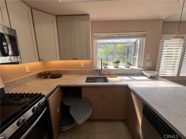 a kitchen with a sink and wooden cabinets
