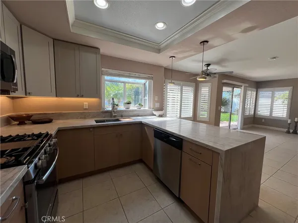 a kitchen with a sink appliances and cabinets