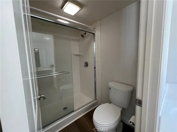 a white toilet next to a bathroom
