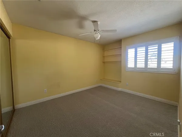 an empty room with a empty space and a ceiling fan
