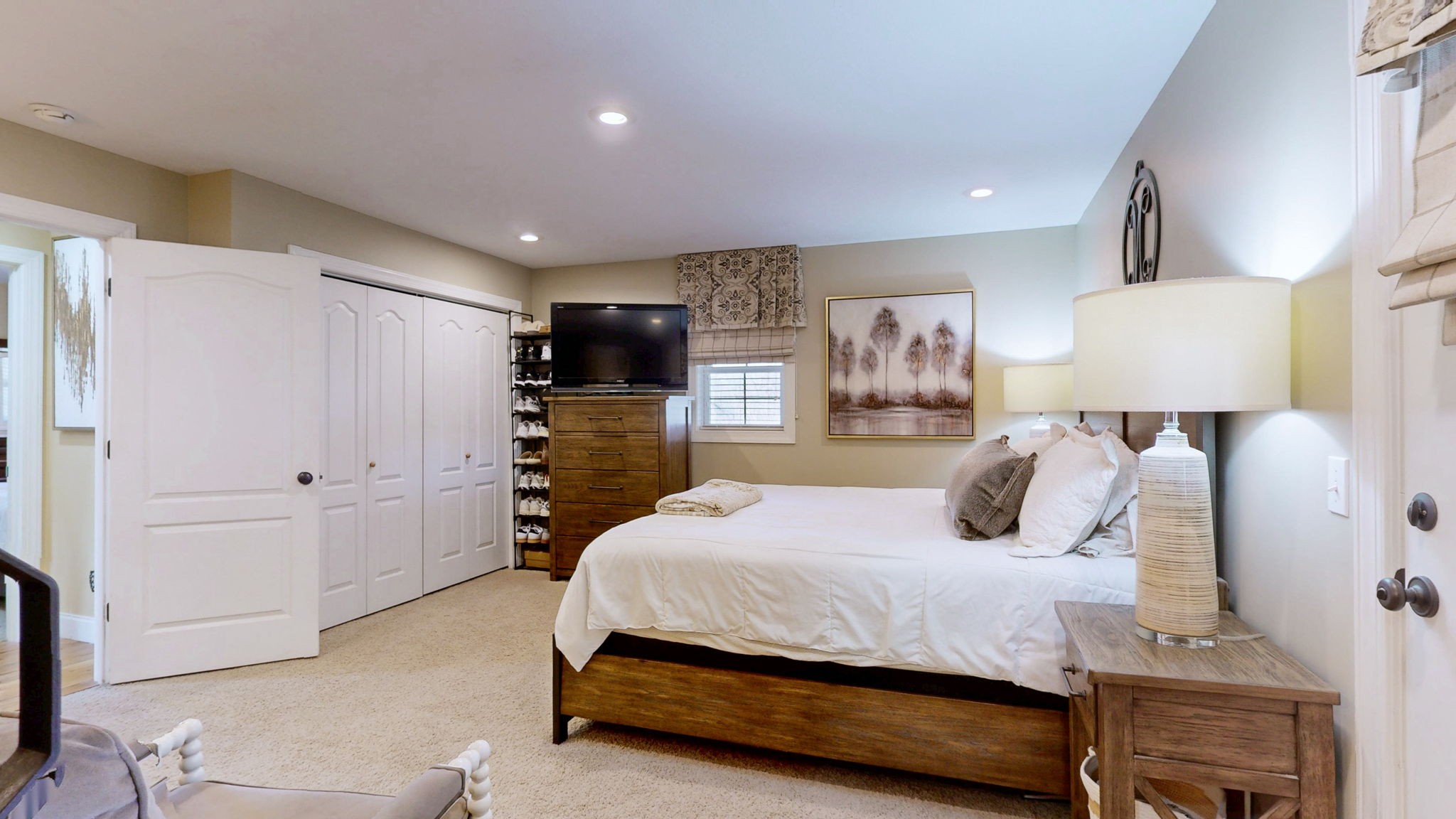 955 Martin Mill Road Puryear, TN 38251 - Photo 11 of 55 a bedroom with a bed and a flat screen tv