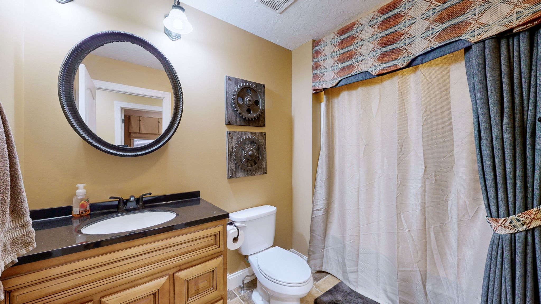 955 Martin Mill Road Puryear, TN 38251 - Photo 15 of 55 a bathroom with a sink a mirror a toilet and a window