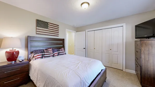 a bedroom with a bed and tv