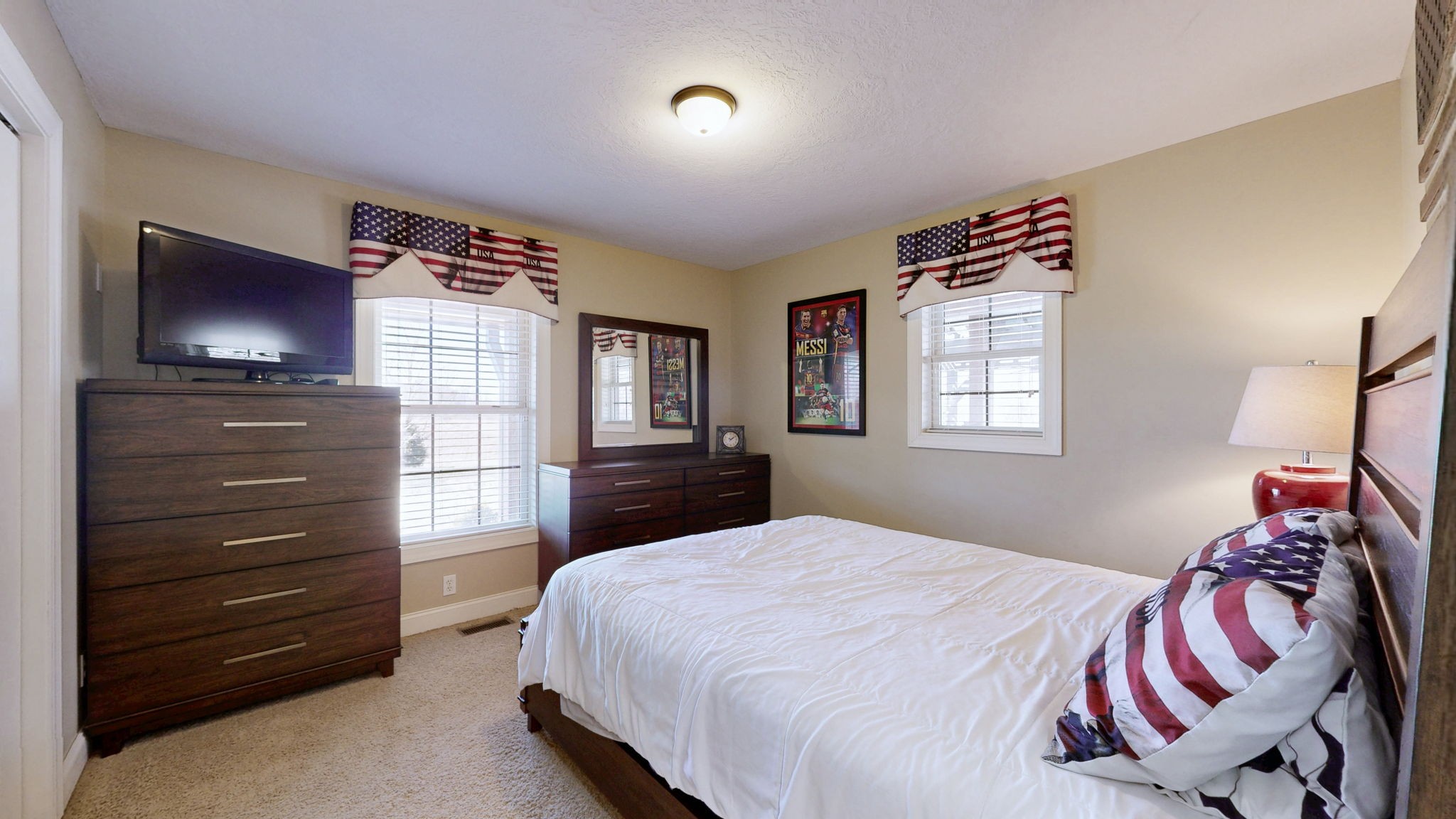 955 Martin Mill Road Puryear, TN 38251 - Photo 17 of 55 a bedroom with a bed and a flat screen tv