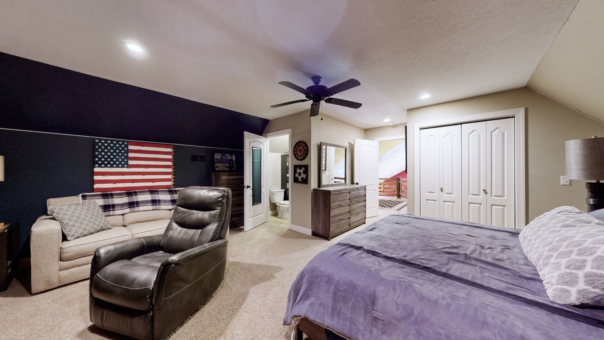 955 Martin Mill Road Puryear, TN 38251 - Photo 20 of 55 a spacious bedroom with a bed a couch and a chandelier