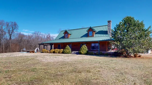 a view of the house with a yard