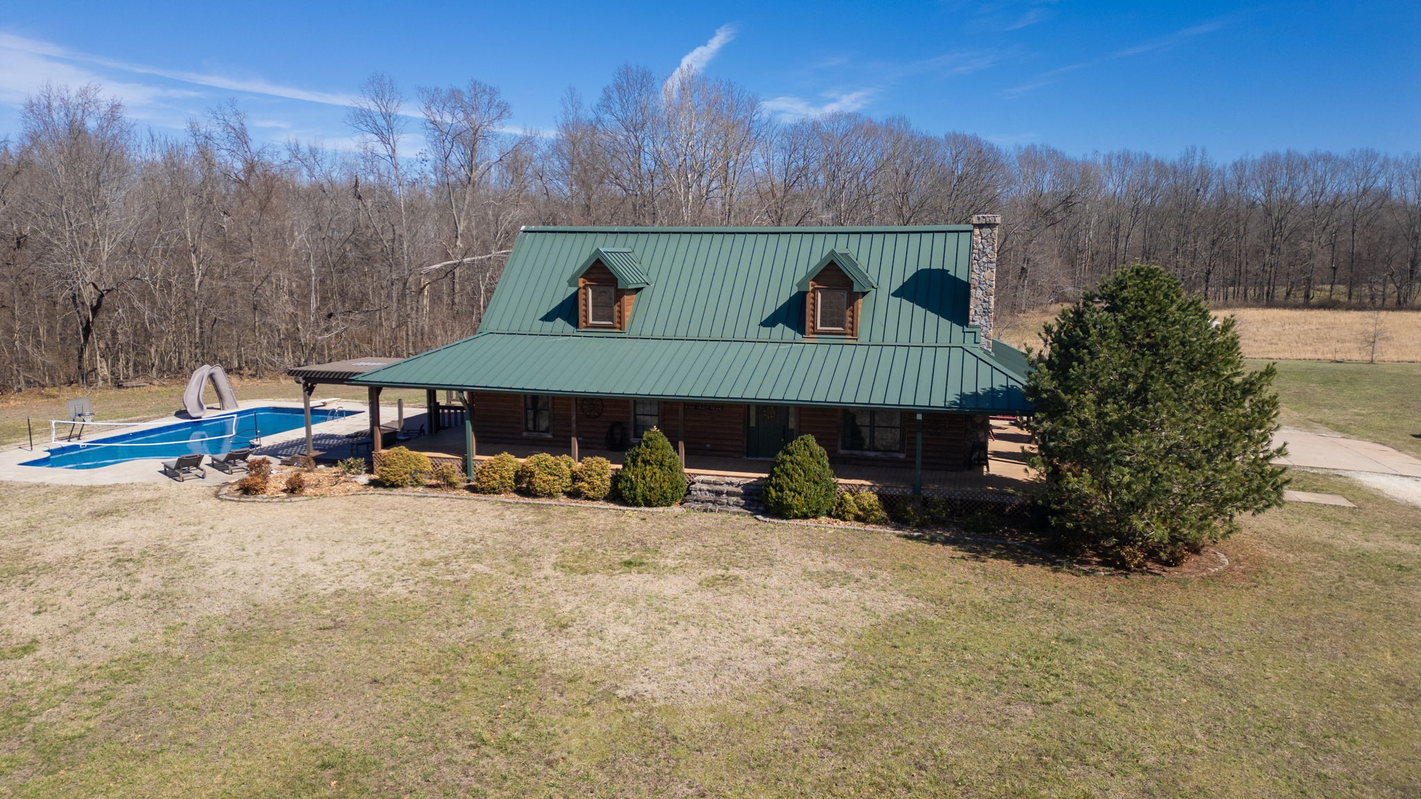 955 Martin Mill Road Puryear, TN 38251 - Photo 43 of 55 a view of backyard with a table and chairs under an umbrella