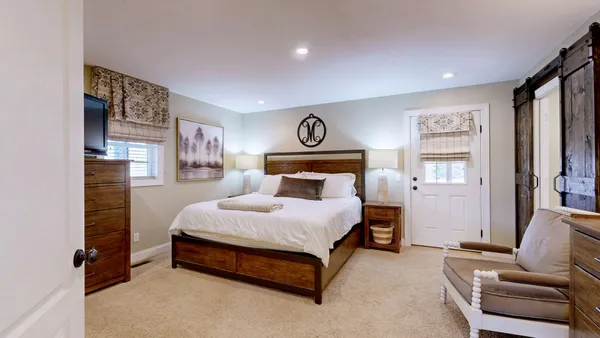 a spacious bedroom with a bed and a couch
