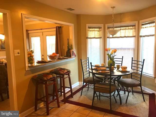 9202 Oregold Court Laurel, MD 20708 - Photo 11 of 29 a view of a dining room with furniture and windows