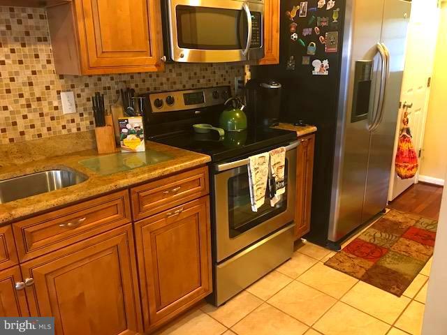 9202 Oregold Court Laurel, MD 20708 - Photo 9 of 29 a kitchen with stainless steel appliances granite countertop a refrigerator and a stove