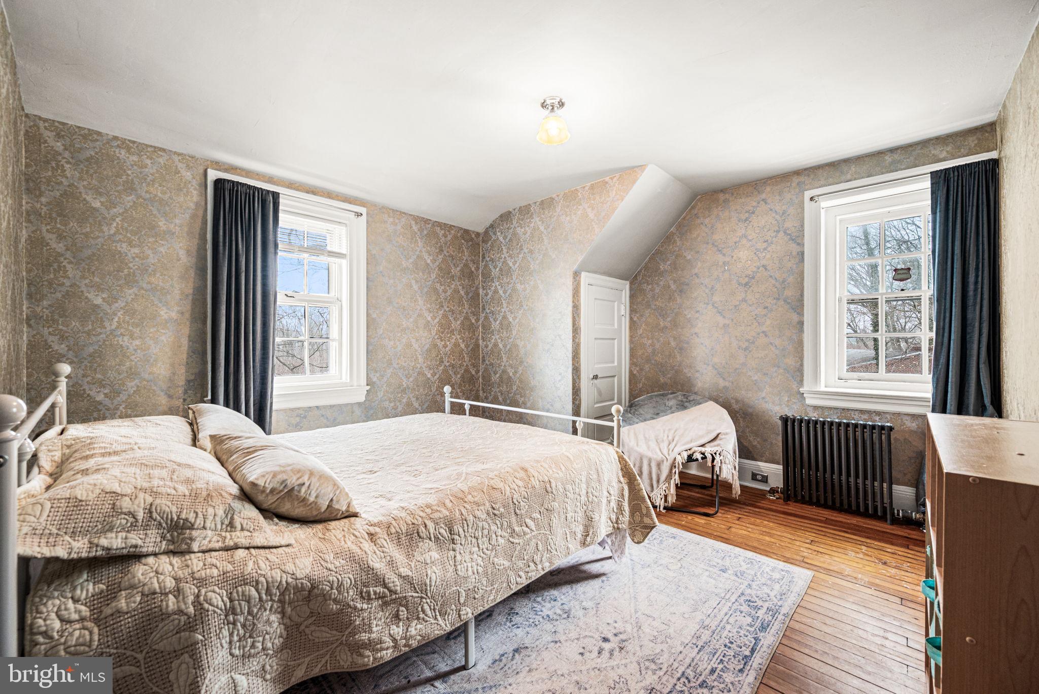1018 Beech Road Wallingford, PA 19086 - Photo 59 of 66 a bedroom with a bed and wooden floor