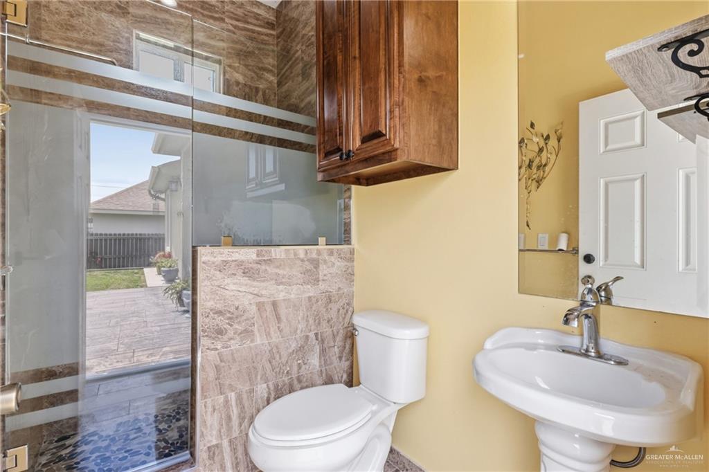 717 West 27th Street Mission, TX 78574 - Photo 15 of 18 a bathroom with a sink a toilet and shower