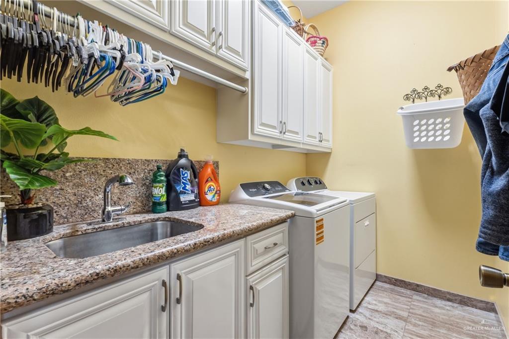717 West 27th Street Mission, TX 78574 - Photo 16 of 18 a kitchen with stainless steel appliances granite countertop a sink a stove and a wooden floor