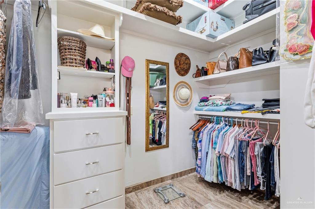 717 West 27th Street Mission, TX 78574 - Photo 17 of 18 a view of walk in closet with clothes and shoes