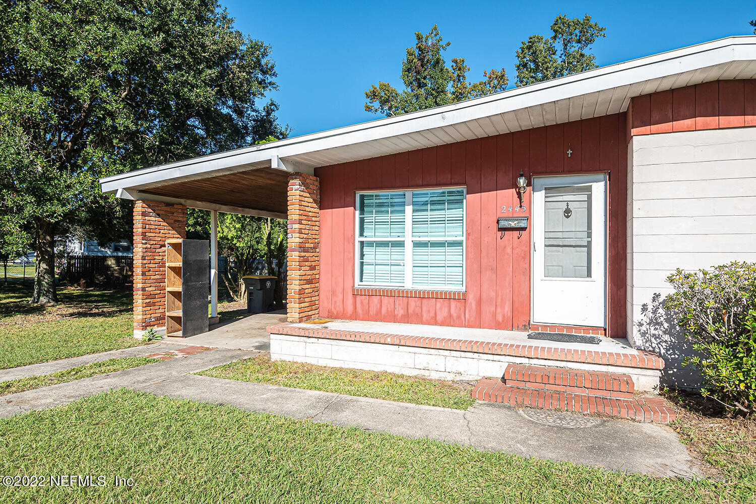 2445 Community Road Jacksonville, FL 32207 - Photo 11 of 42 a front view of a house with a yard