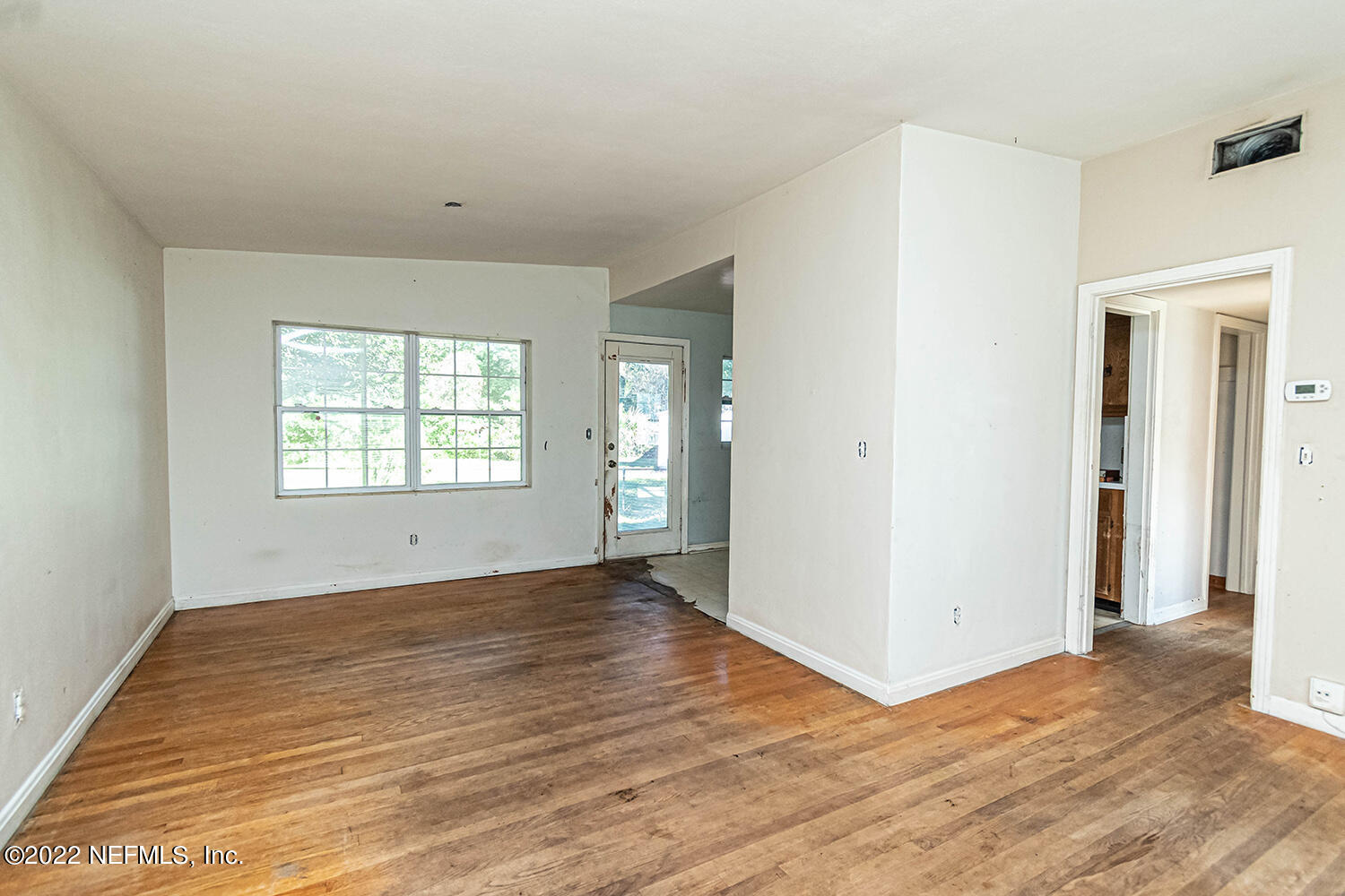 2445 Community Road Jacksonville, FL 32207 - Photo 14 of 42 an empty room with wooden floor and windows