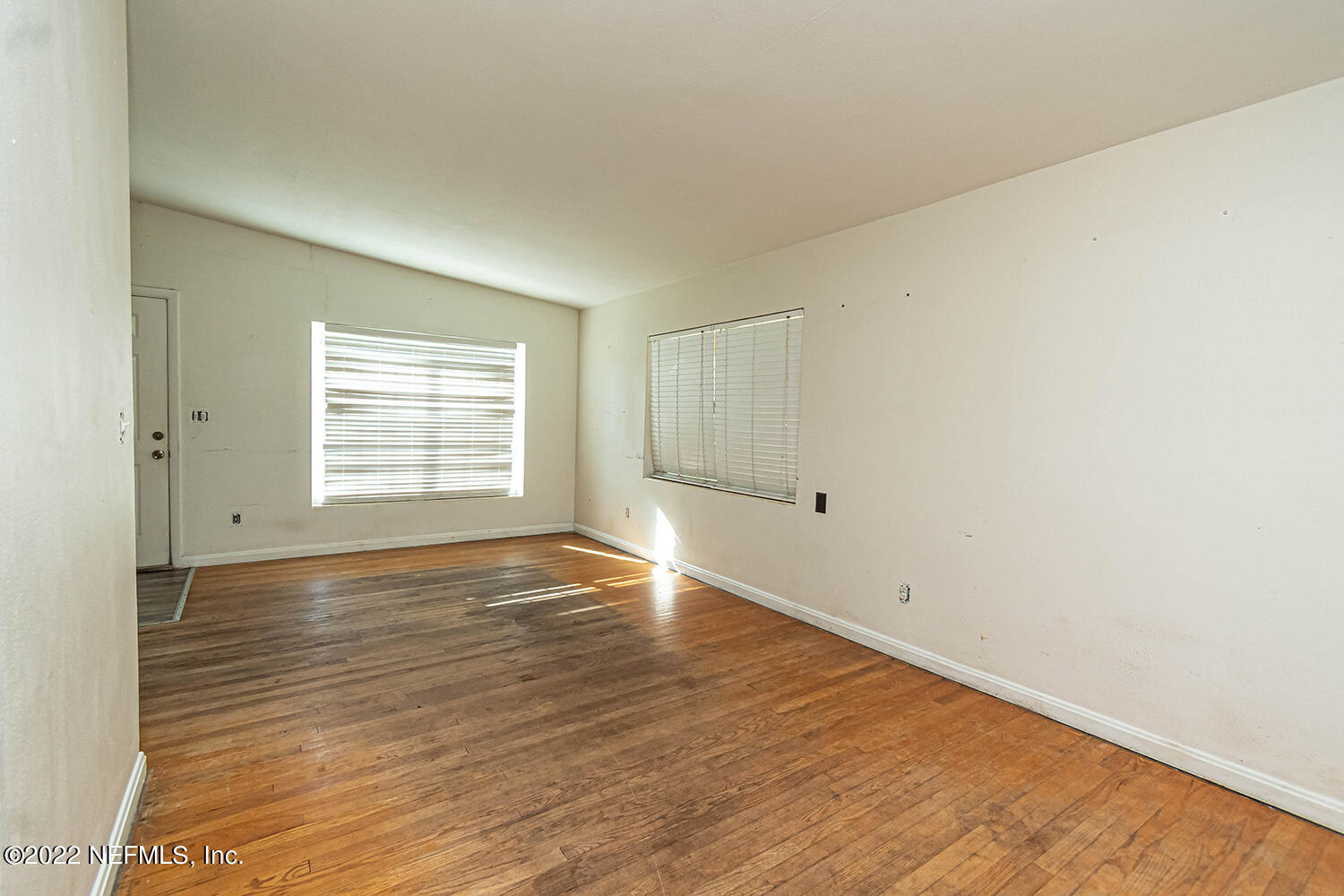 2445 Community Road Jacksonville, FL 32207 - Photo 15 of 42 an empty room with wooden floor and windows