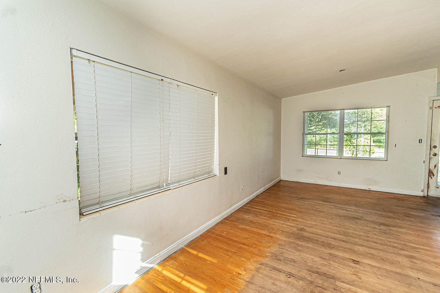 2445 Community Road Jacksonville, FL 32207 - Photo 17 of 42 an empty room with wooden floor cabinet and windows