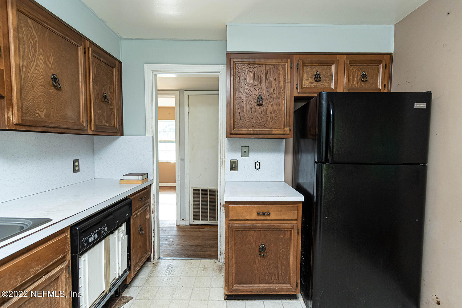 2445 Community Road Jacksonville, FL 32207 - Photo 19 of 42 a kitchen with a refrigerator and a sink